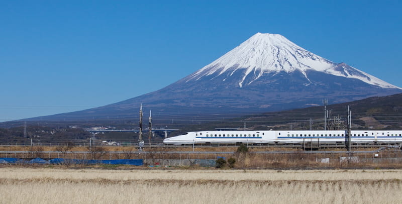 Shinkansen bullet train passing Mount Fuji in Japan