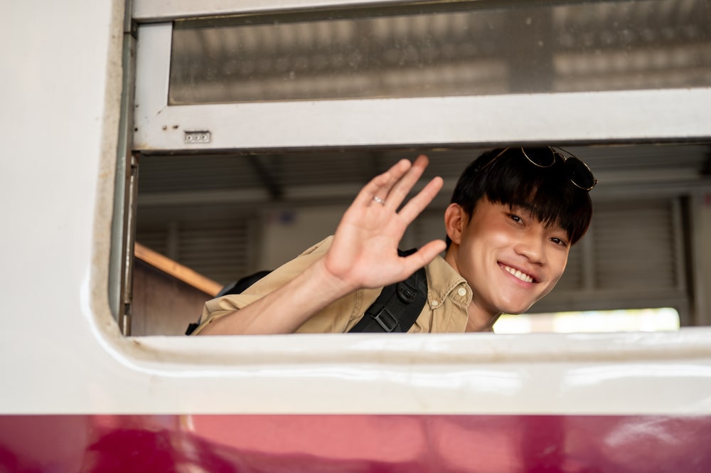 Young adult saying goodbye at train station in Japan